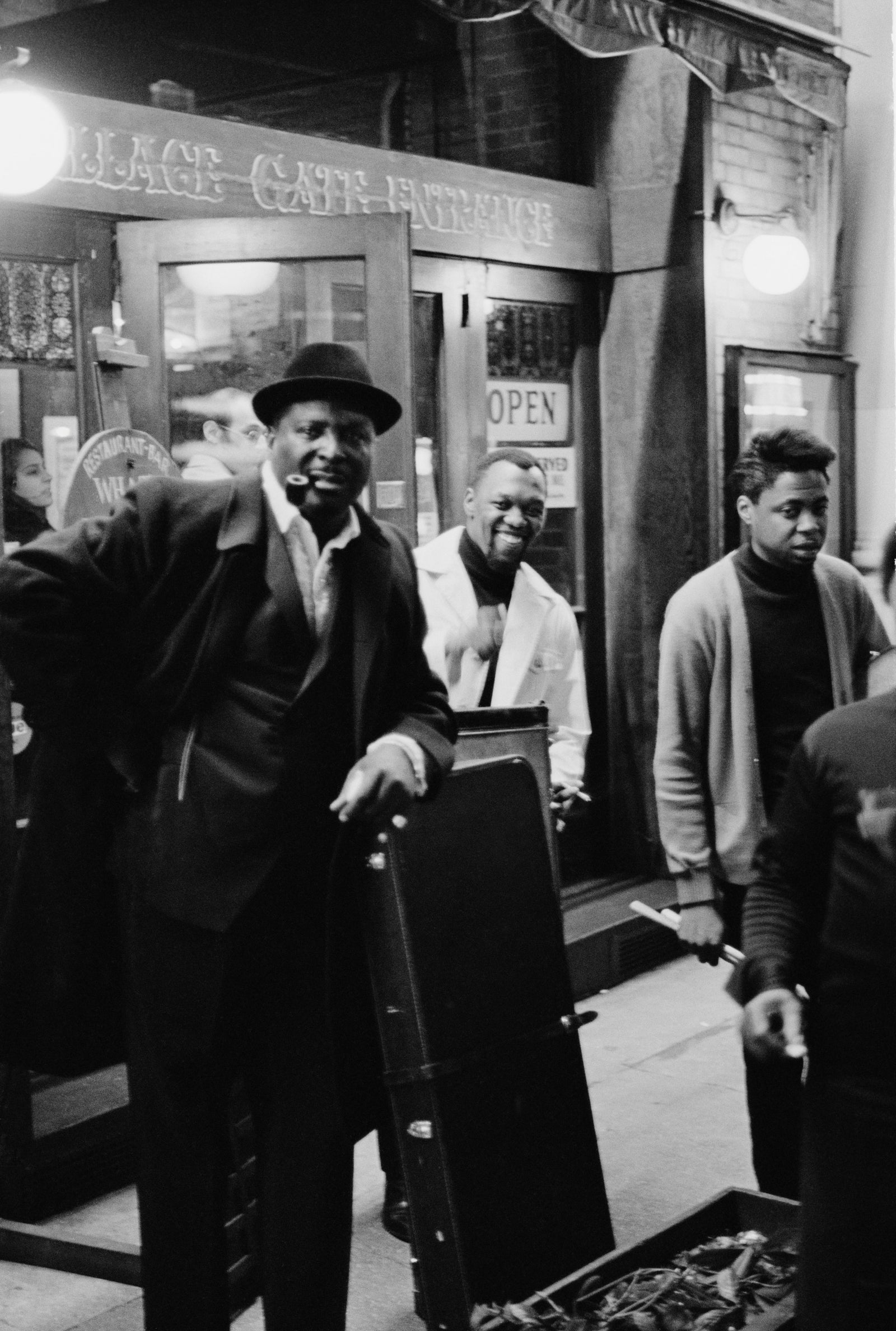 Black and white photograph of blues guitarist Albert King in a hat outside the Village Gate nightclub, New York, 1969