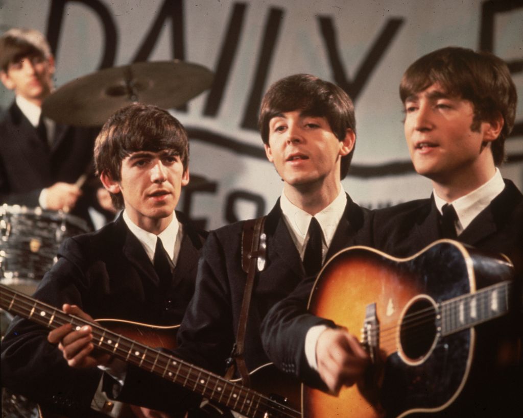 Colour photograph of The Beatles performing in matching suits on Granada TV in Manchester, 1963