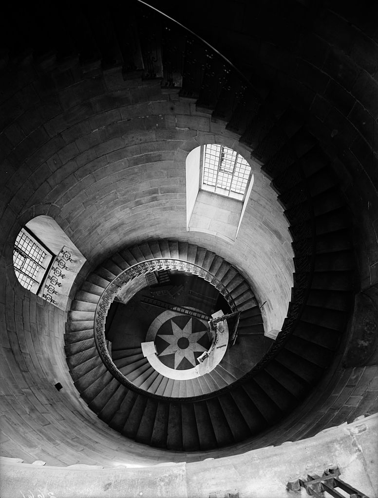 Black and white photograph looking down the spiralling geometric staircase at St Paul's Cathedral, London, 1937