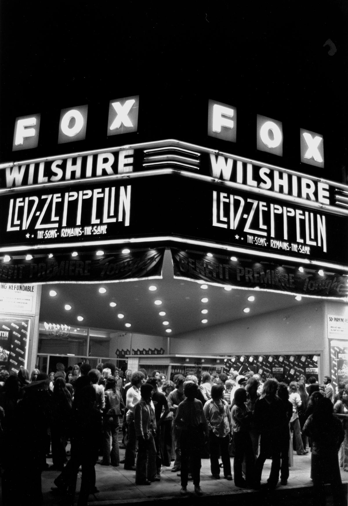Black and white photograph of the illuminated Fox Wilshire theatre marquee announcing Led Zeppelin's The Song Remains the Same, Los Angeles, 1976