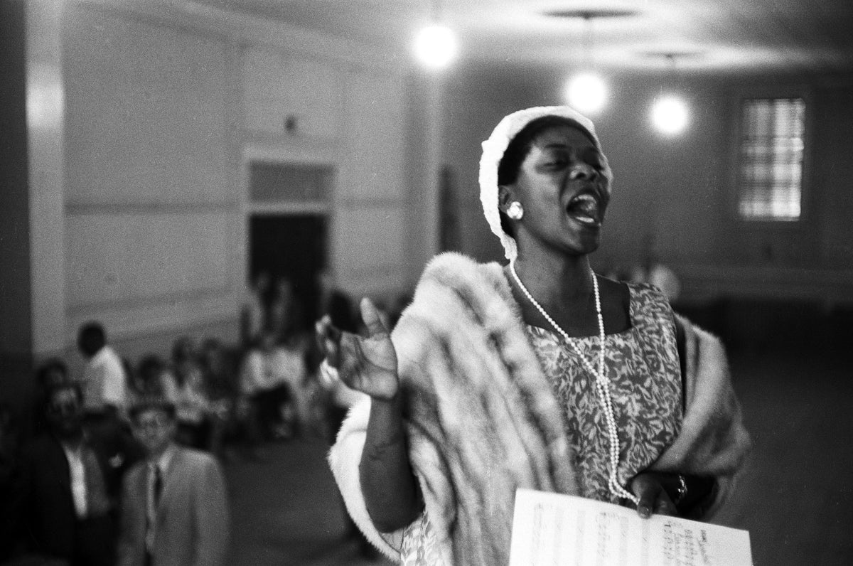 Black and white photograph of Dinah Washington singing at a church service during the Newport Jazz Festival, Rhode Island, 1958