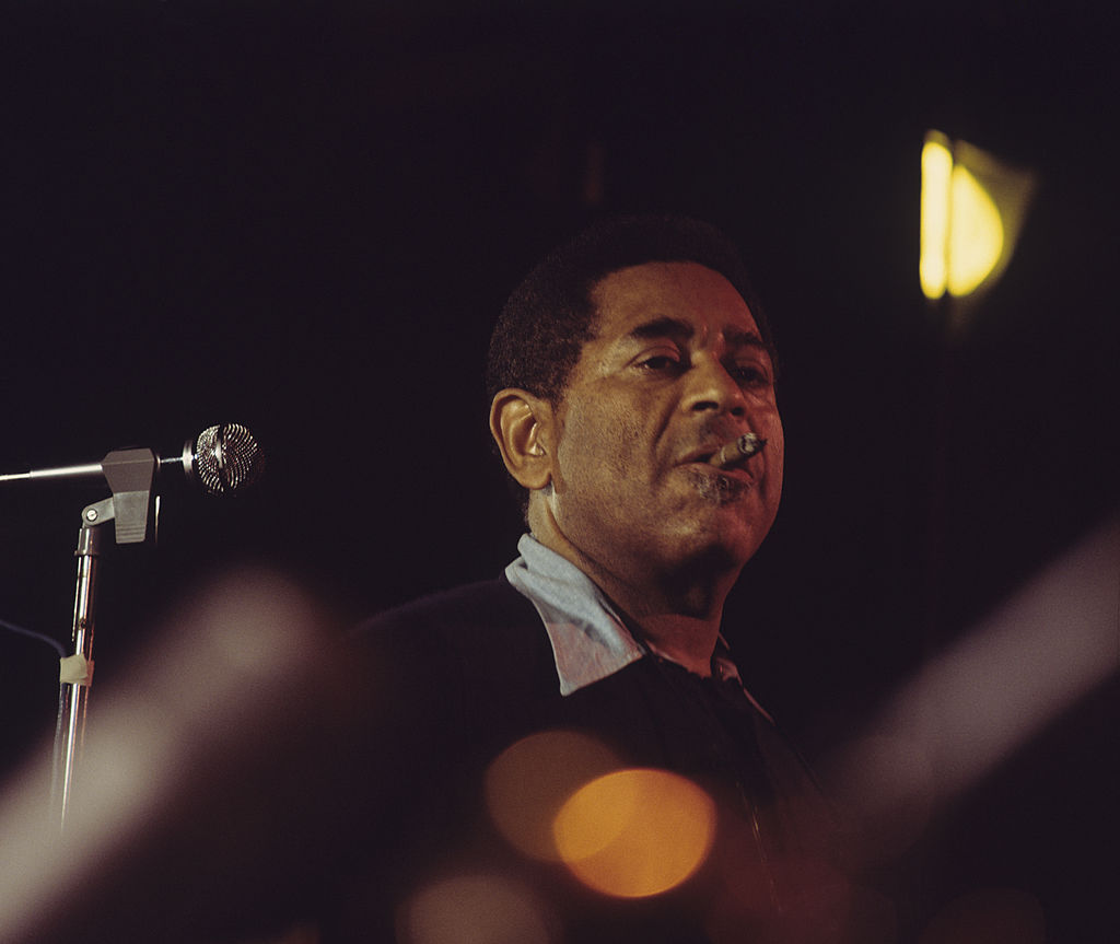 Colour photograph of Dizzy Gillespie on stage in warm stage light at Ronnie Scott's, London, 1974