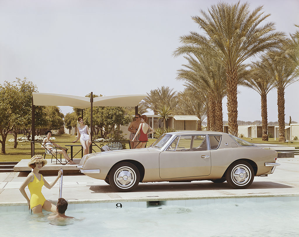 Friends Having Fun Near Pool by Archive Photos/Getty Images, 1962. A Studebaker Avanti by a swimming pool. Open Edition C-Type Photographic Print. Landscape orientation. Available at Electric Gallery, London, UK.
