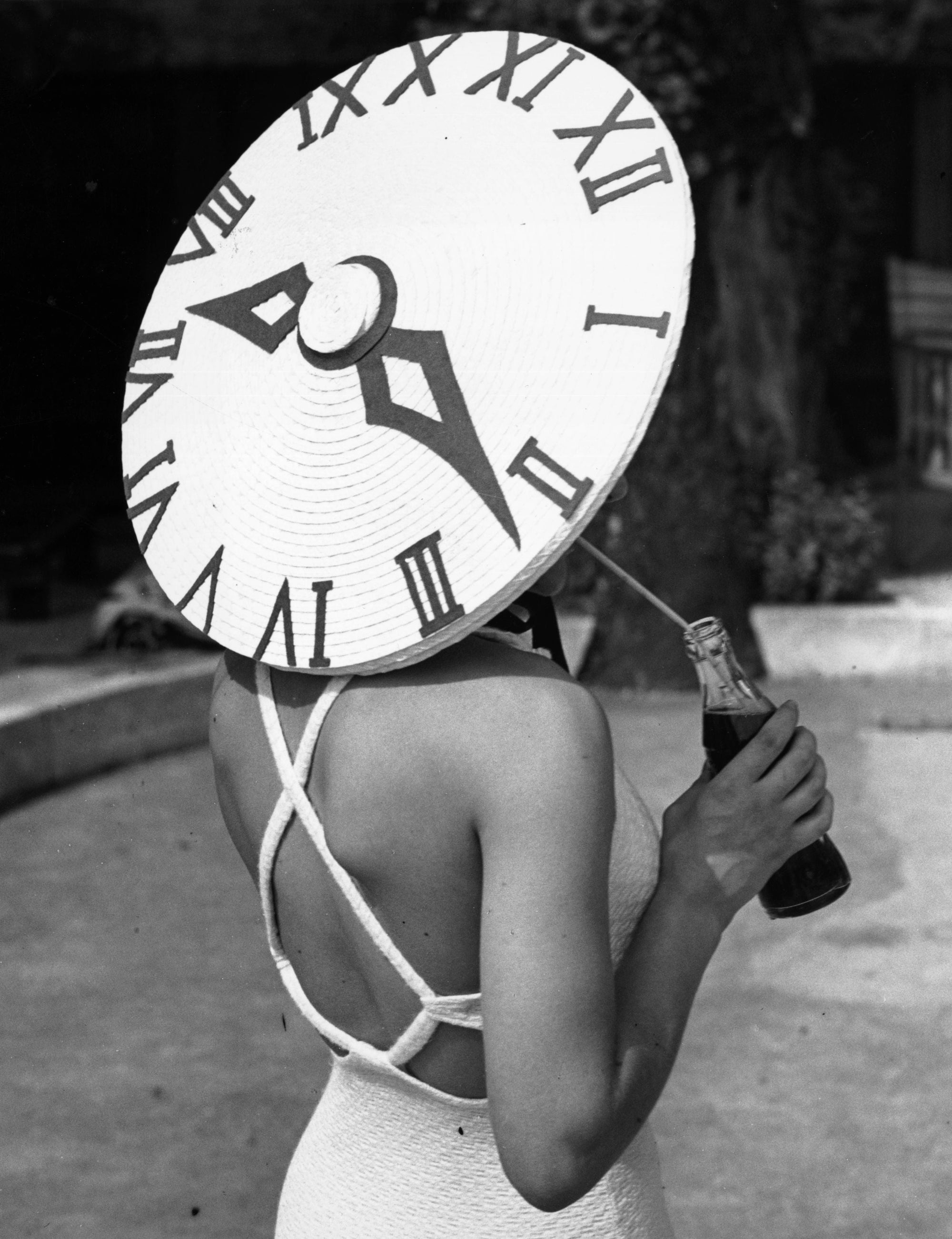 Sundial Hat by Gerry Cranham/Getty Images. British dancer Rosemary Andree wearing a sunhat with a clock face design on a summer's day at the Roehampton Pool.. Open Edition Resin Photographic Print. Portrait orientation. Available at Electric Gallery, London, UK.