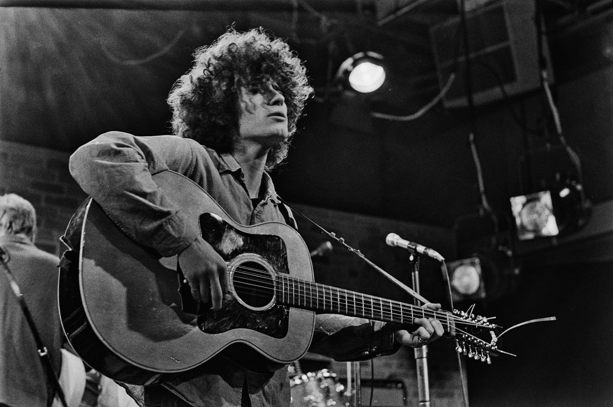 Black and white photograph of Tim Buckley playing a twelve-string acoustic guitar at The Bitter End, New York, 1967