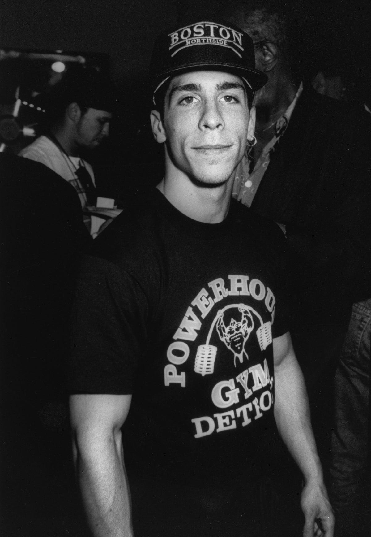 Black and white photograph of Danny Wood of New Kids on the Block in a Boston cap and Powerhouse Gym t-shirt, circa 1990