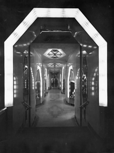 Black and white photograph of a glowing illuminated art deco entrance at the Strand Palace Hotel, London
