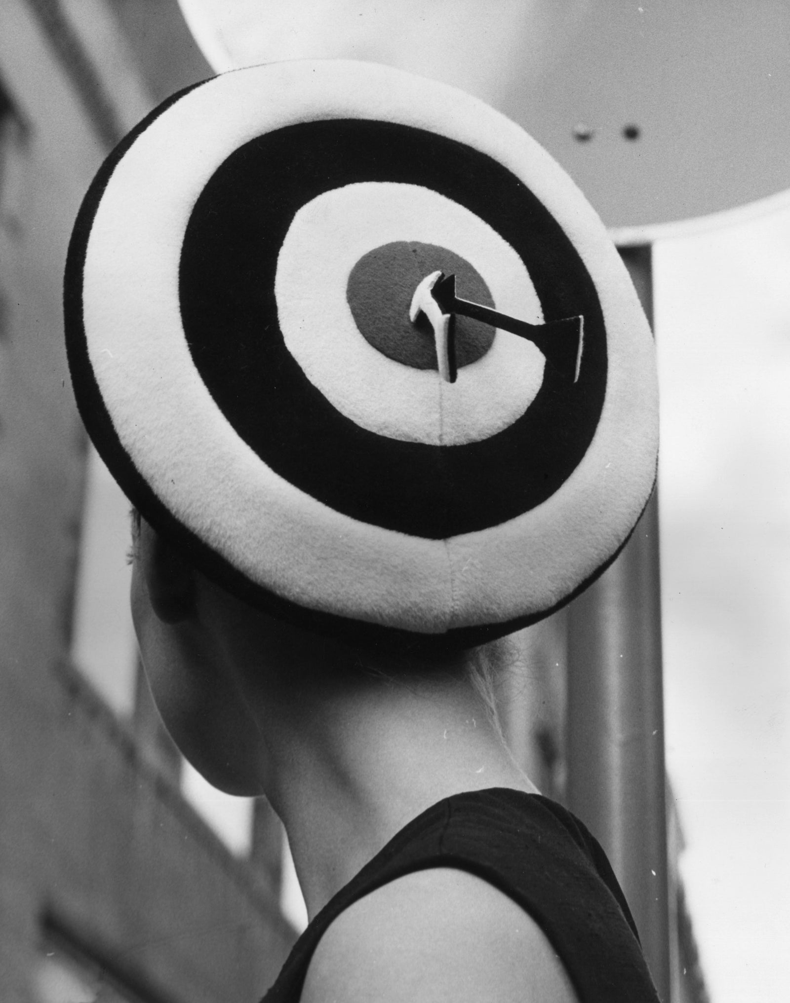 Black and white photograph of a model wearing a bullseye target beret by Simone Mirman, London, 1966