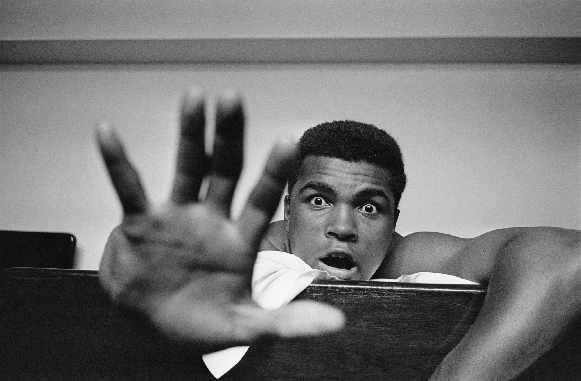 Give Me Five by Len Trievnor/Getty Images, 1963. American Heavyweight boxer Cassius Clay lying on his hotel bed in London.. Open Edition Resin Photographic Print. Landscape orientation. Available at Electric Gallery, London, UK.