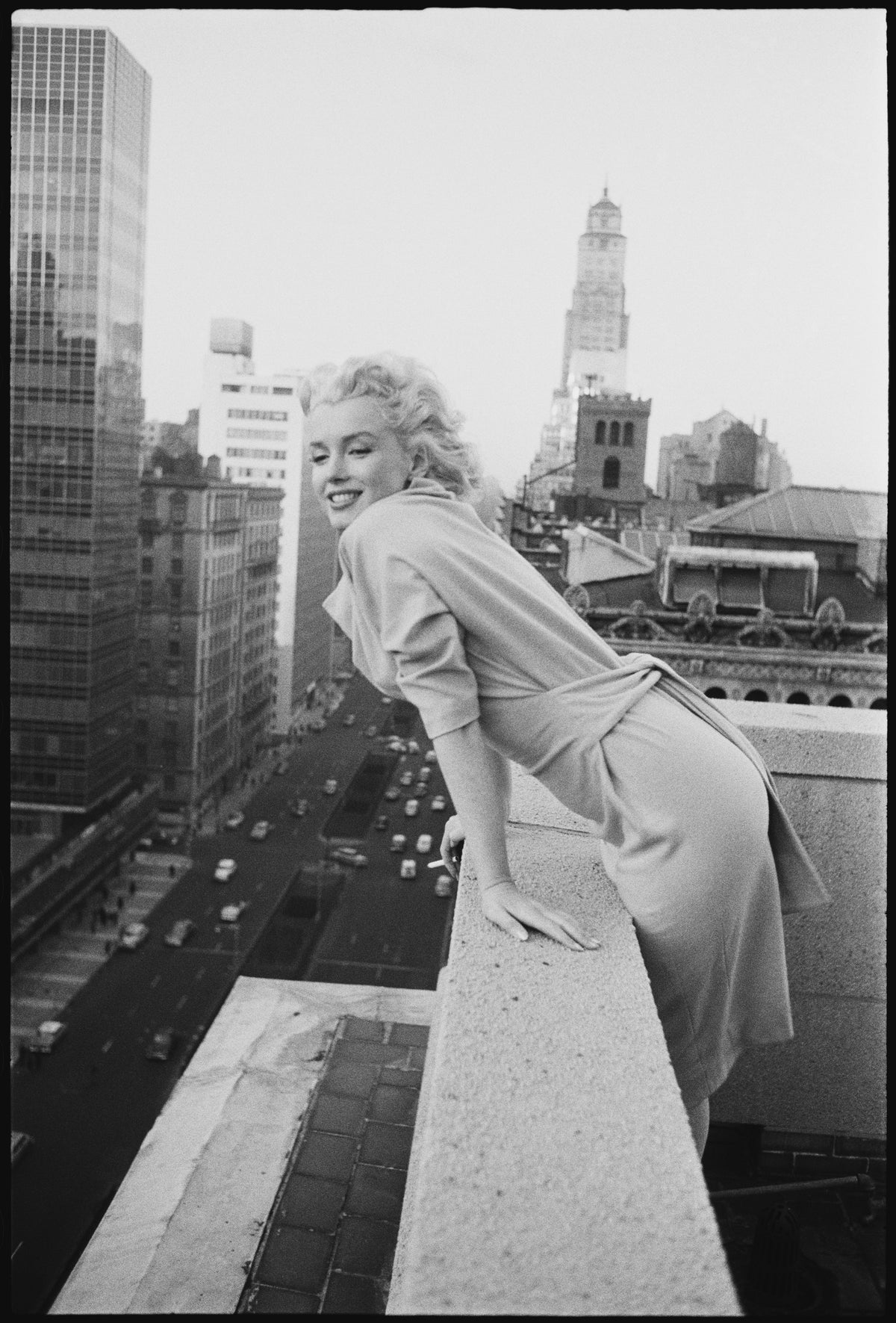 Marilyn On The Roof by Michael Ochs/Getty Images, 1955. American actress Marilyn Monroe leans over the balcony of the Ambassador Hotel in. Open Edition Resin Photographic Print. Portrait orientation. Available at Electric Gallery, London, UK.