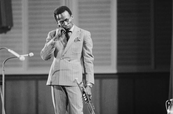 Miles In Germany by Michael Ochs/Getty Images, 1959. Jazz trumpeter and composer Miles Davis plays trumpet as he performs onstage in circa. Open Edition Resin Photographic Print. Portrait orientation. Available at Electric Gallery, London, UK.