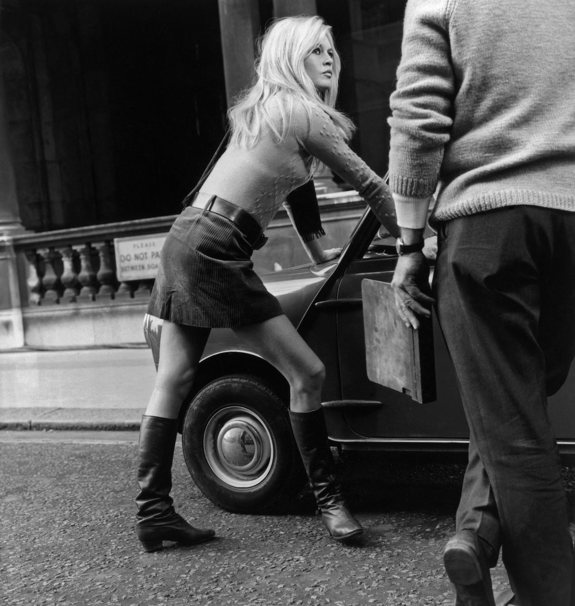 Mini Car Mini Skirt by Michael Webb/Getty Images, 1966. Brigitte Bardot during a break from filming, 'Two Weeks in September' in Whitehall, London.. Open Edition Resin Photographic Print. Square orientation. Available at Electric Gallery, London, UK.