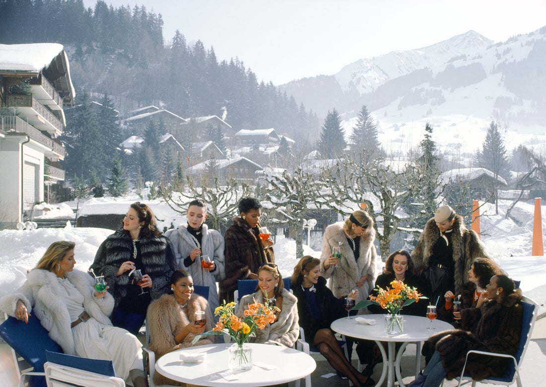 Drinks At Gstaad by Slim Aarons/Getty Images, 1984. Open Edition C-Type Photographic Print. Landscape orientation. Available at Electric Gallery, London, UK.