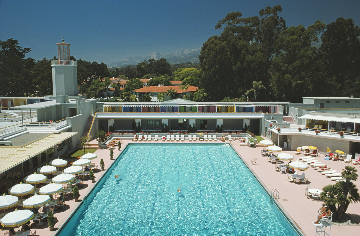 Monte Carlo Pool by Slim Aarons/Getty Images, 1965. White umbrellas line a swimming pool in Monte Carlo. Open Edition C-Type Photographic Print.. Landscape orientation. Available at Electric Gallery, London, UK.