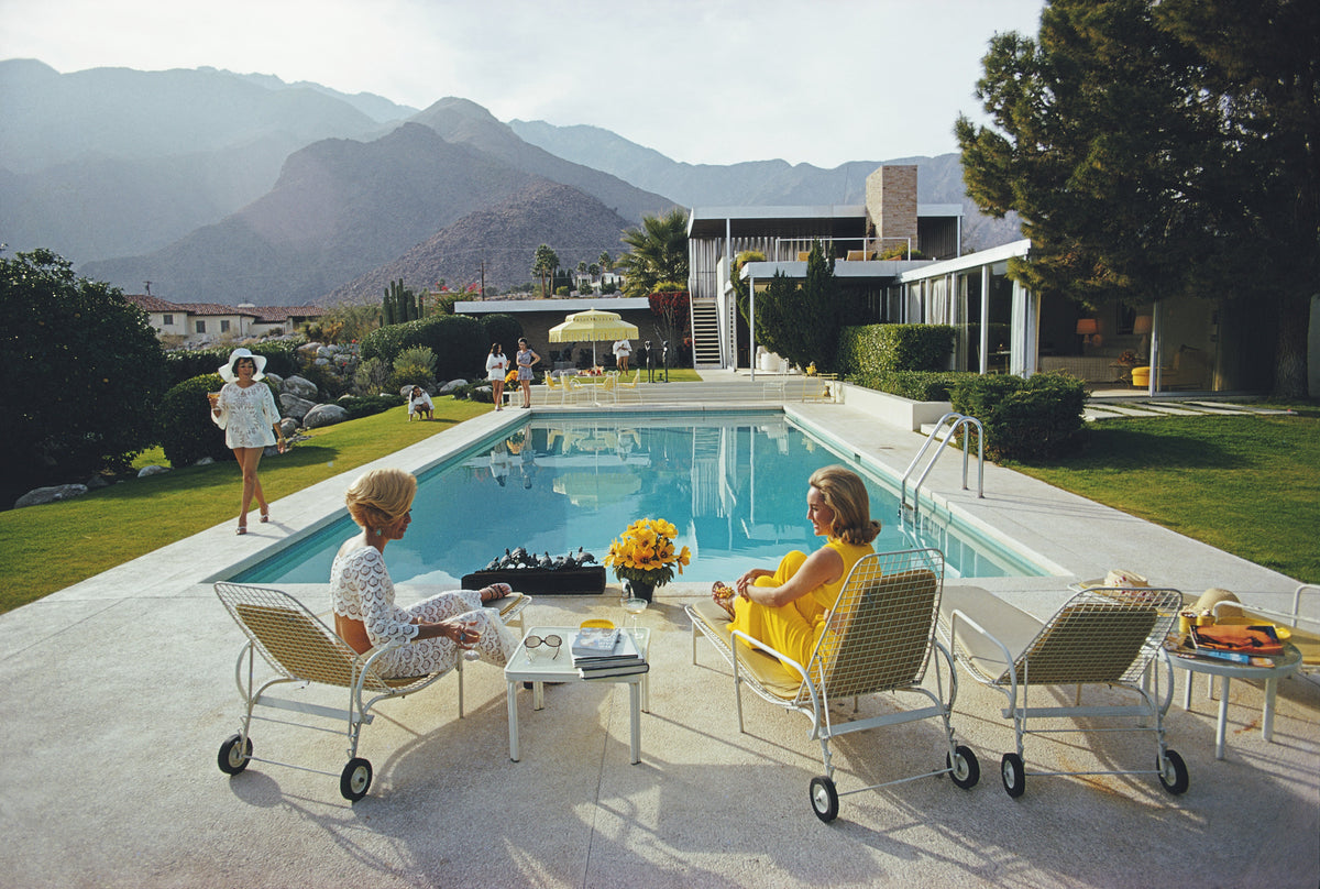 Poolside Gossip by Slim Aarons/Getty Images, 1970. Open Edition C-Type Photographic Print. Landscape orientation. Available at Electric Gallery, London, UK.