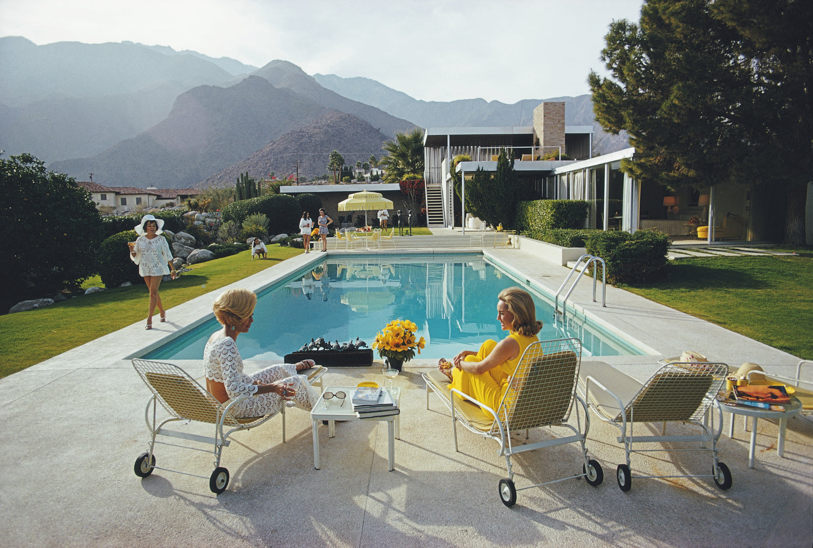 Poolside Gossip by Slim Aarons/Getty Images, 1970. Open Edition C-Type Photographic Print. Landscape orientation. Available at Electric Gallery, London, UK.