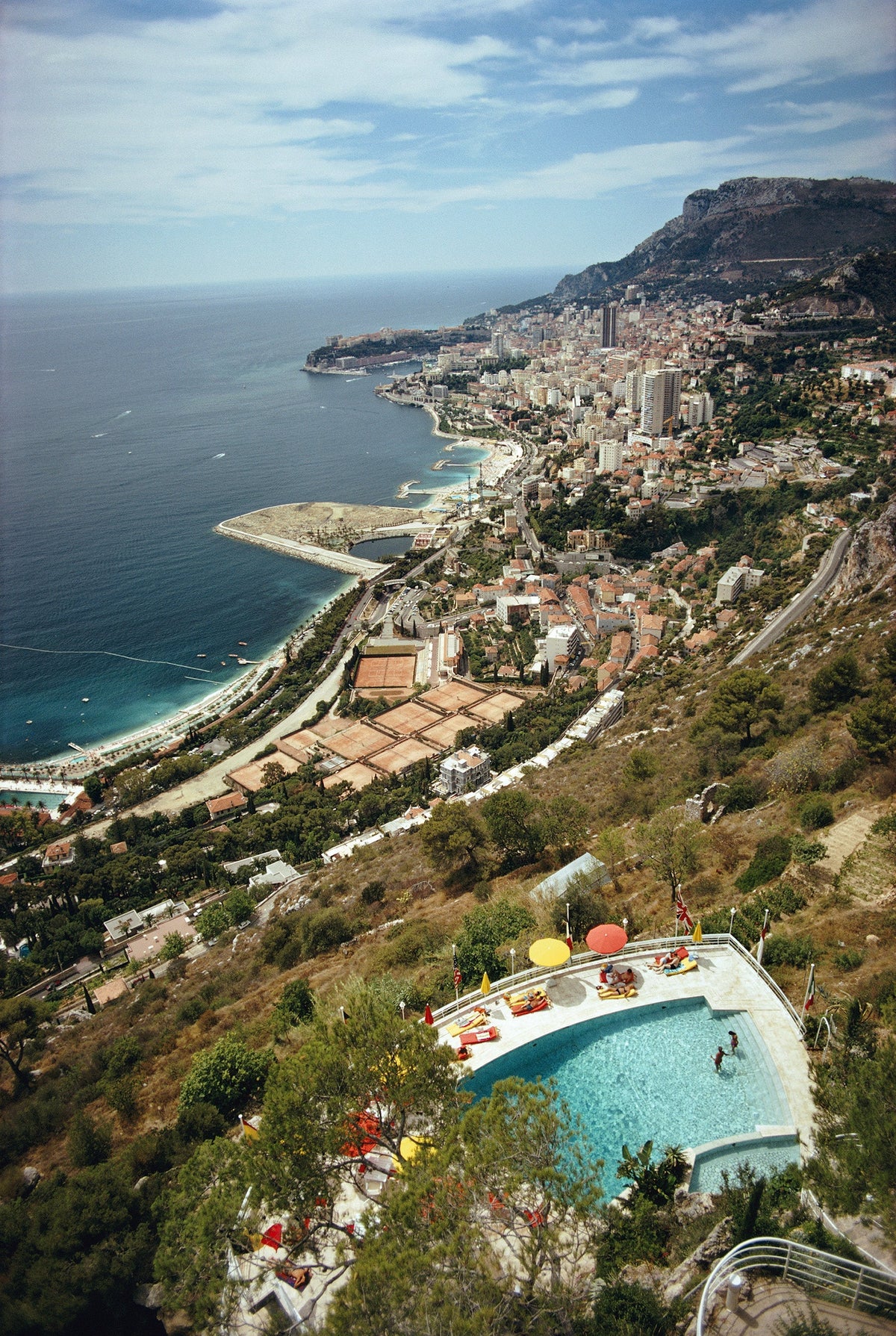 Roquebrune-Cap Martin by Slim Aarons/Getty Images, 1970. A view from a hillside in Roquebrune-Cap-Martin, southeastern France, looking toward Monaco. Open Edition C-Type Photographic Print.. Portrait orientation. Available at Electric Gallery, London, UK.