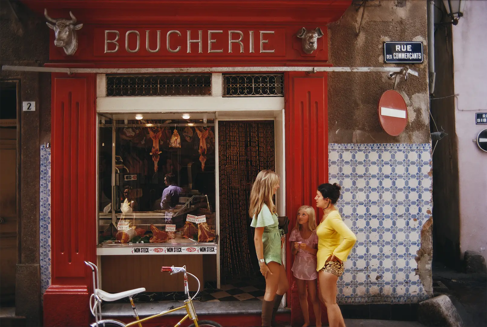 Saint-Tropez Boucherie by Slim Aarons/Getty Images, 1971. A boucherie or butcher’s shop on Rue des Commercants in Saint-Tropez, on the French Riviera. Open Edition C-Type Photographic Print.. Portrait orientation. Available at Electric Gallery, London, UK.