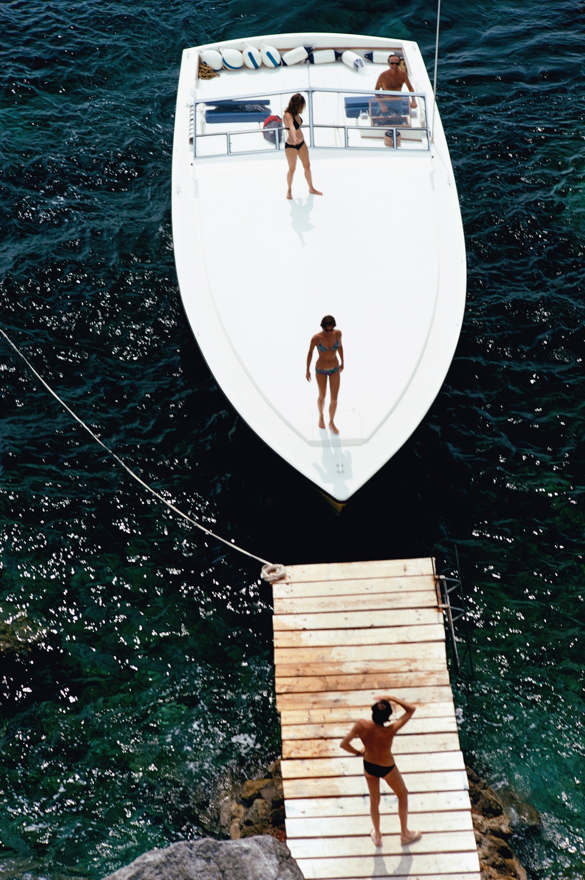 Speedboat Landing by Slim Aarons/Getty Images, 1973. Open Edition C-Type Photographic Print. Portrait orientation. Available at Electric Gallery, London, UK.