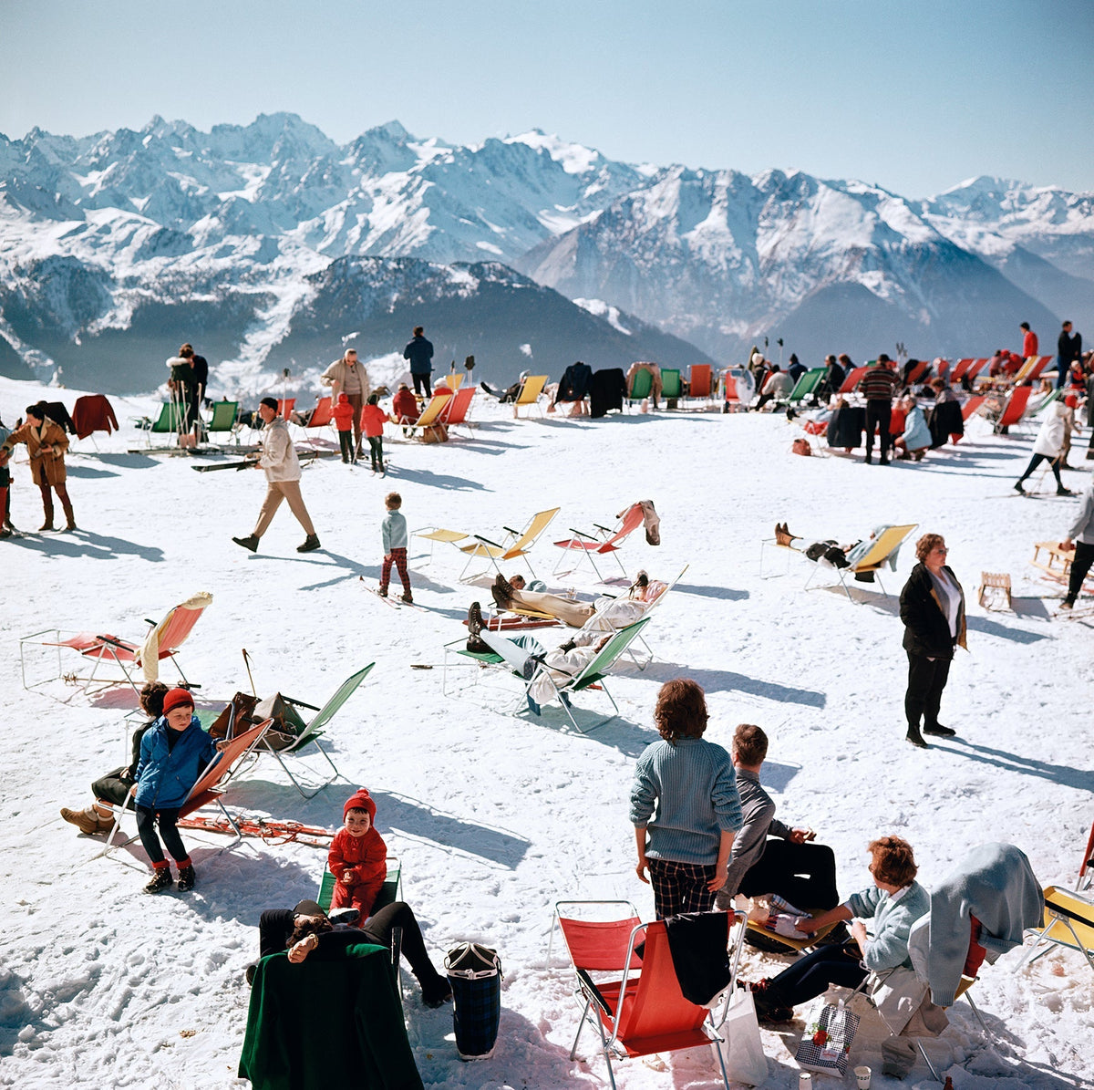 Verbier Vacation by Slim Aarons/Getty Images, 1964. Holiday-makers take the sun on a mountain top in Verbier. Open Edition C-Type Photographic Print. Square orientation. Available at Electric Gallery, London, UK.