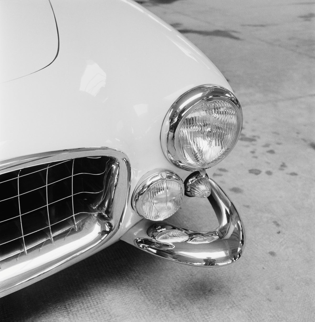 Maserati Bumper by Thurston Hopkins/Getty Images, 1956. The bumper of an Italian Maserati sports car at the Paris Motor Show.. Open Edition Resin Photographic Print. Square orientation. Available at Electric Gallery, London, UK.
