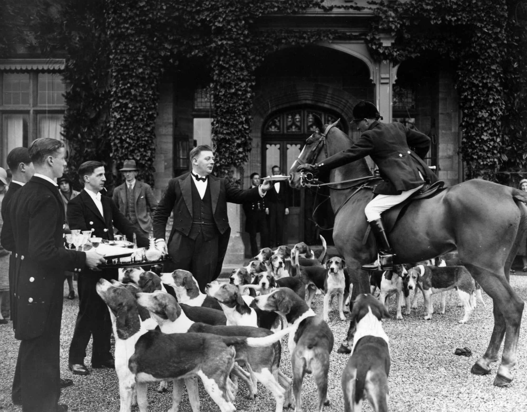 Stirrup Cup by Topical Press Agency/Getty Images, 1931. At Cowdray park, Midhurst, Sussex handing round a 'stirrup cup' at a hunt meet during 'coming of age' festivities for Lord Cowdray's heir.. Open Edition Resin Photographic Print. Landscape orientation. Available at Electric Gallery, London, UK.