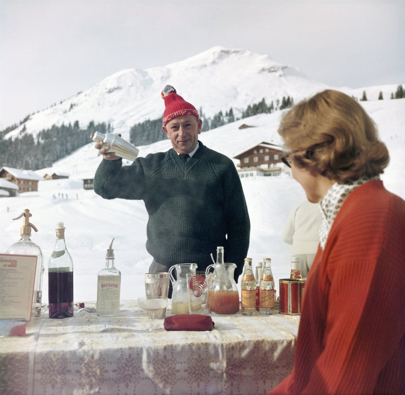 Lech Ice Bar by Slim Aarons/Getty Images. A bartender mixes a drink for a customer at the Ice Bar at the Hotel Krone in Lech, Austria. Available at Electric Gallery, London, UK.