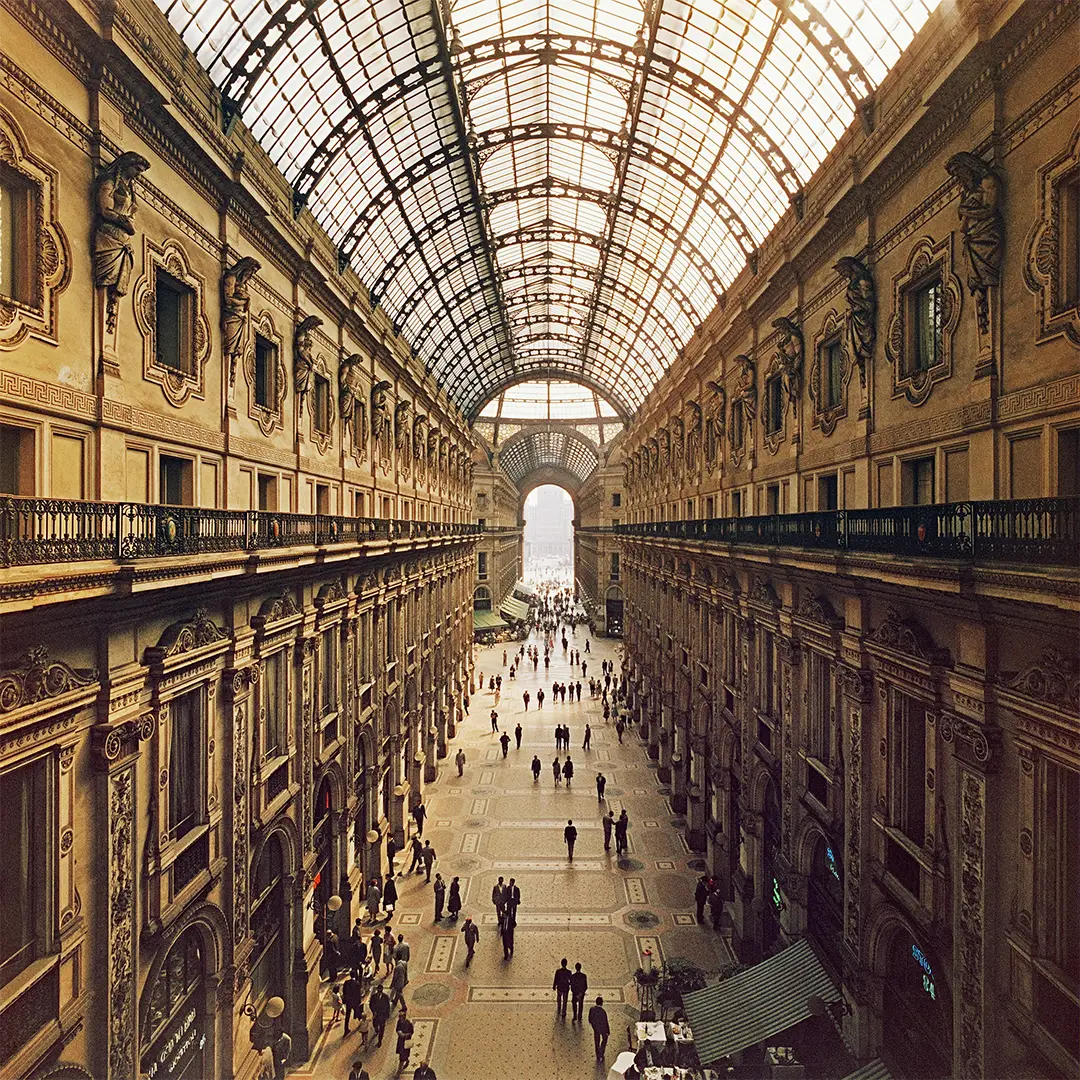 Galleria Vittorio Emanuele II by Slim Aarons/Getty Images, 1960. View looking down the Galleria Vittorio Emanuele II in Milan, Italy. Open Edition C-Type Photographic Print. Square orientation. Available at Electric Gallery, London, UK.