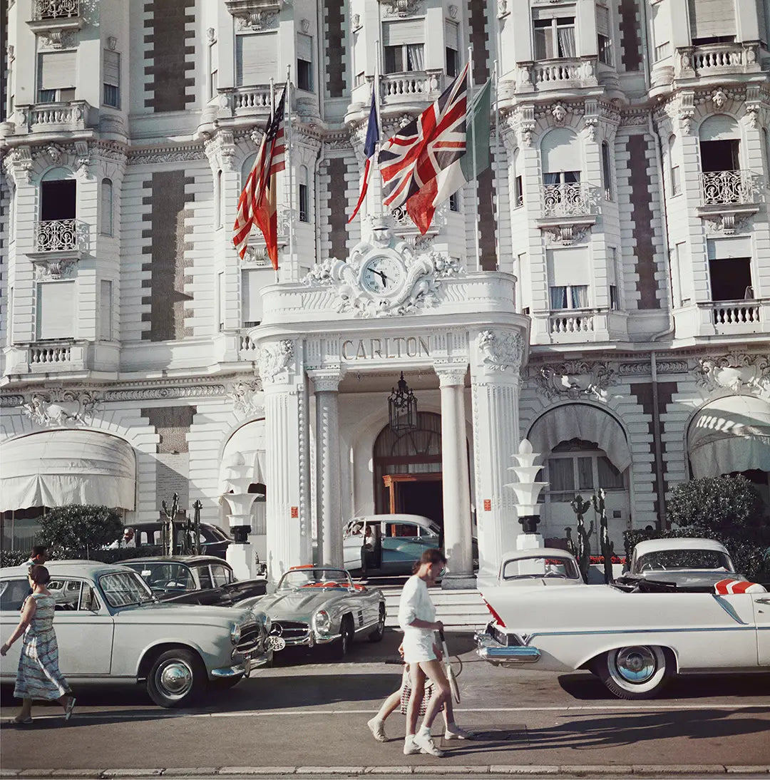 Carlton Hotel by Slim Aarons/Getty Images, 1958. The entrance to the Carlton Hotel, Cannes, France. Open Edition C-Type Photographic Print. Square orientation. Available at Electric Gallery, London, UK.