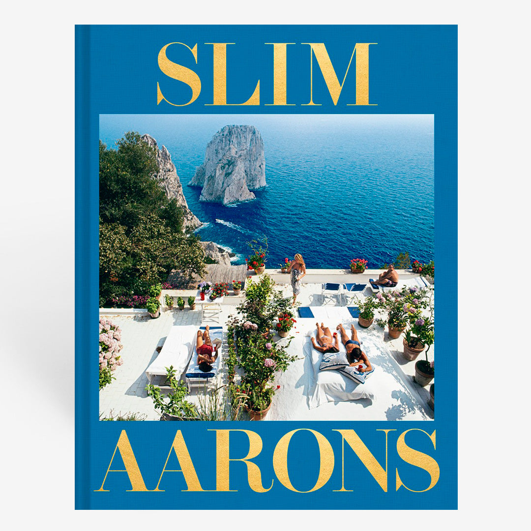Slim Aarons book cover with a scenic view of Capri Island and people by a pool.