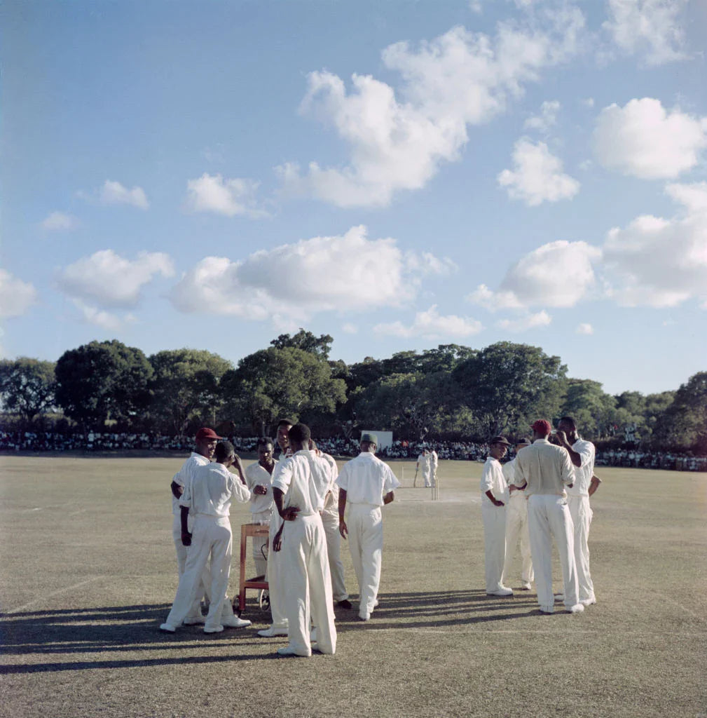 Cricketers on the field during a match between the Leeward Islands and the MCC, Antigua, West Indies, 1960. Slim Aarons photograph.