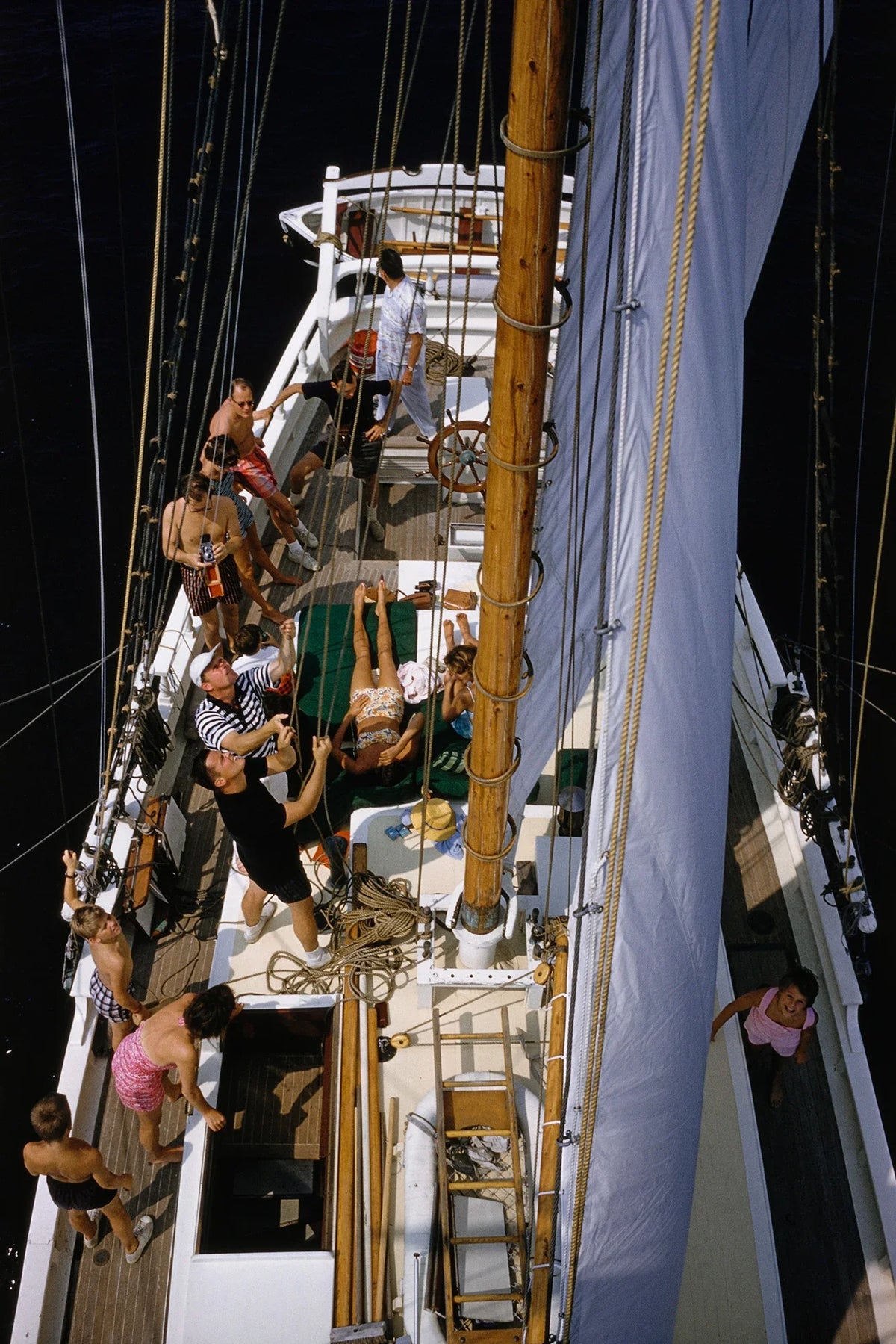 Henry B. Cabot Jr. with his host Barclay H Warburton III aboard the brigantine 'Black Pearl', circa 1959. They are sailing off North Shore, Boston, around Manchester and Marblehead harbors, Essex County, Massachusetts. Slim Aarons photograph.