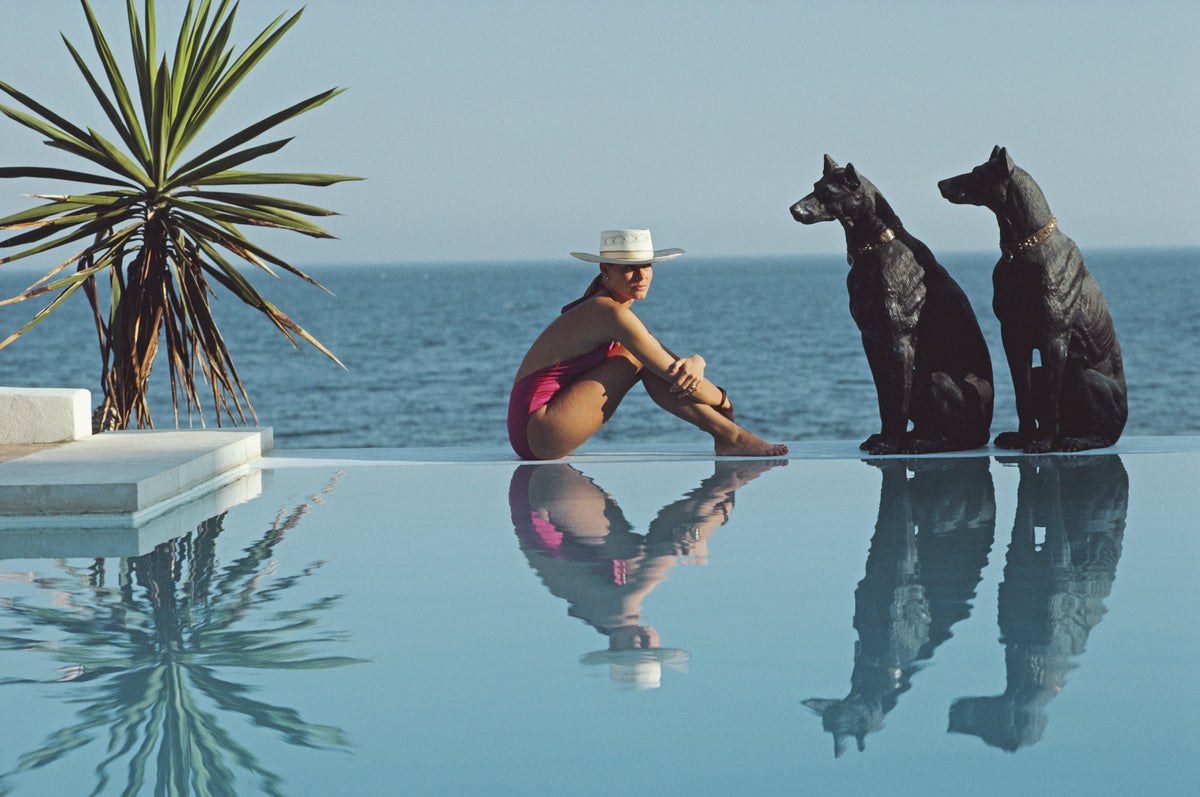 Laura Hawk, assistant to the photographer, relaxes by the pool at El Rincon, the von Pantz' Marbella home, Marbella, Spain, 1985. Slim Aarons photograph.