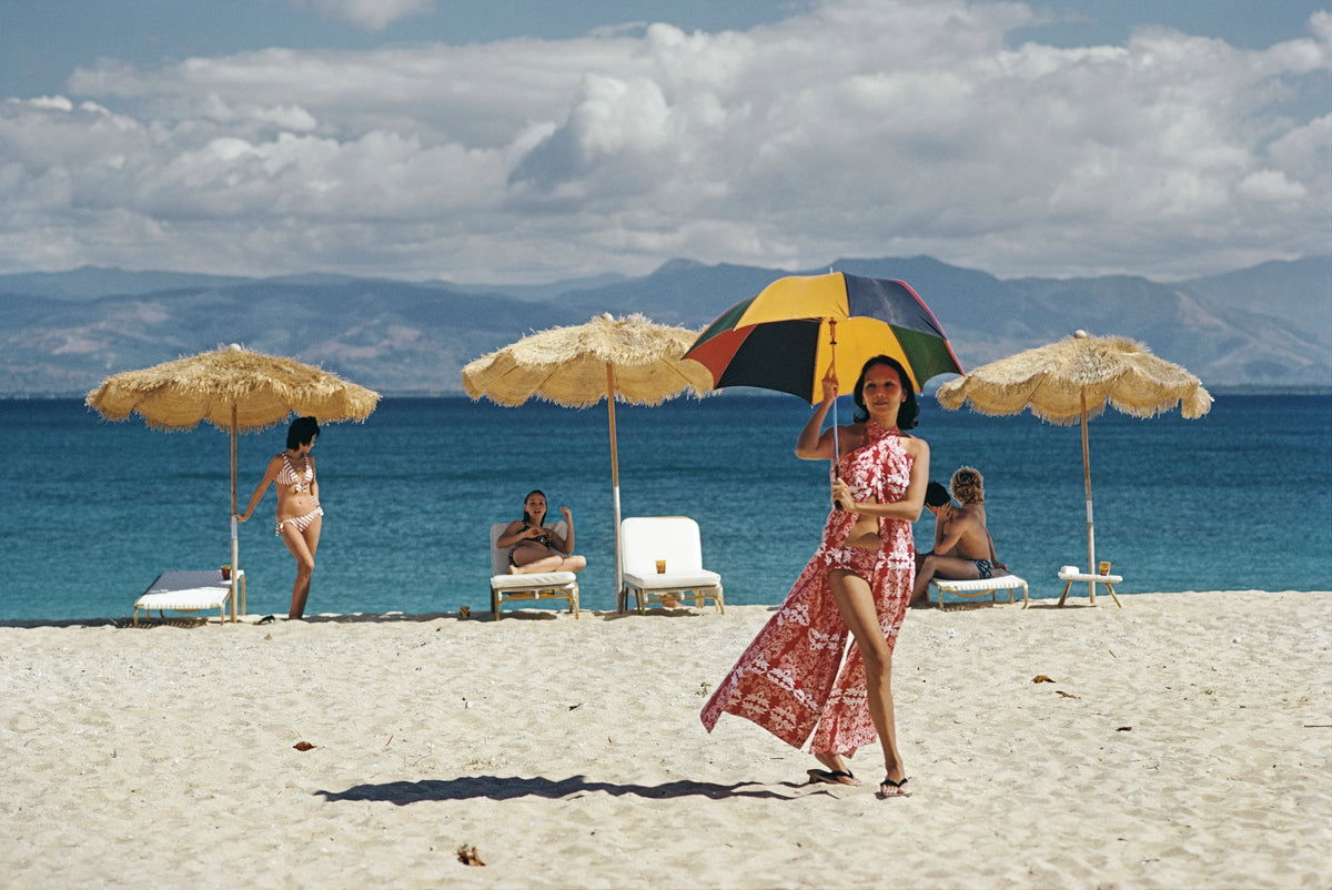 Guests relax on the beach of a private island owned by Philippine Airlines President, Benigno Toda Jr., Philippines, February 1973. Slim Aarons photograph.