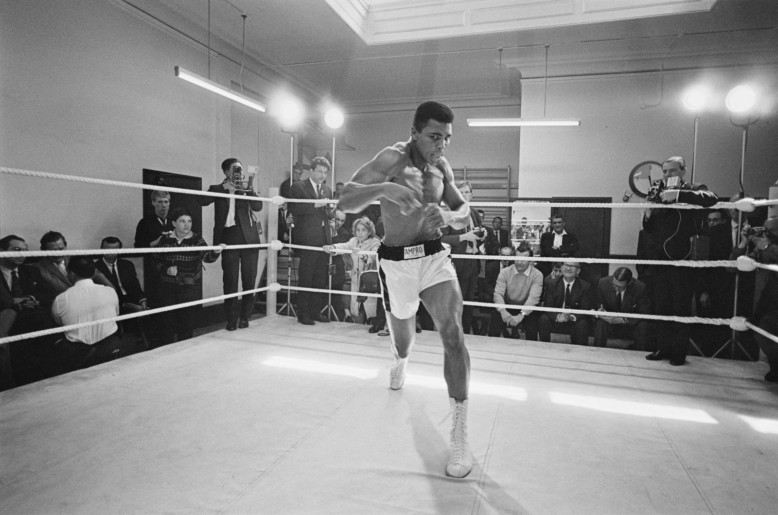 Ali In Training by Russell McPhedran/Getty Images, 1966. American heavyweight boxer Muhammad Ali throws bare-handed punches in the ring while in training for his fight against Brian London, London, England. Open Edition Resin Photographic Print. Landscape orientation. Available at Electric Gallery, London, UK.