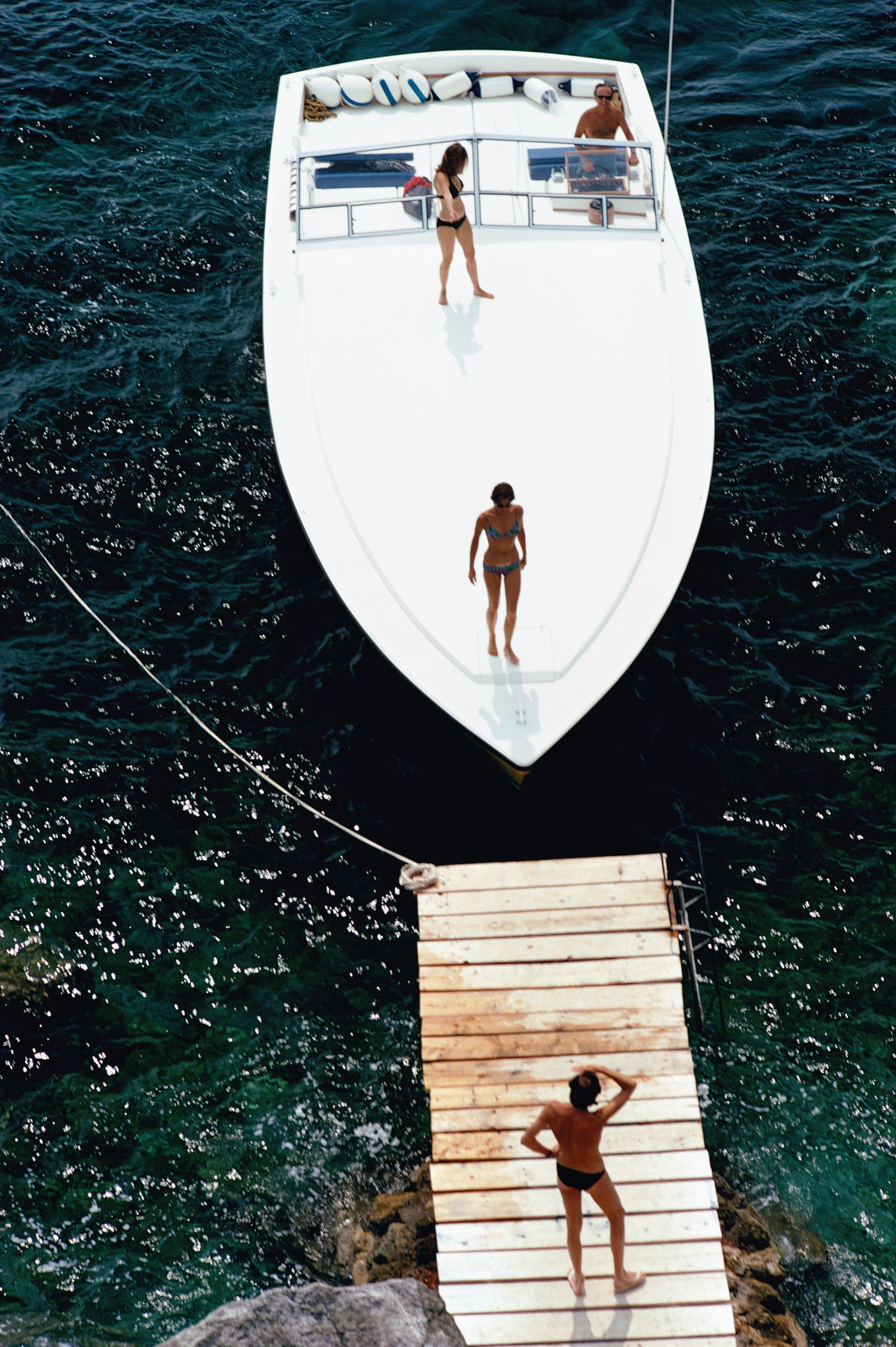 Speedboat Landing by Slim Aarons/Getty Images, 1973. Open Edition C-Type Photographic Print. Portrait orientation. Available at Electric Gallery, London, UK.