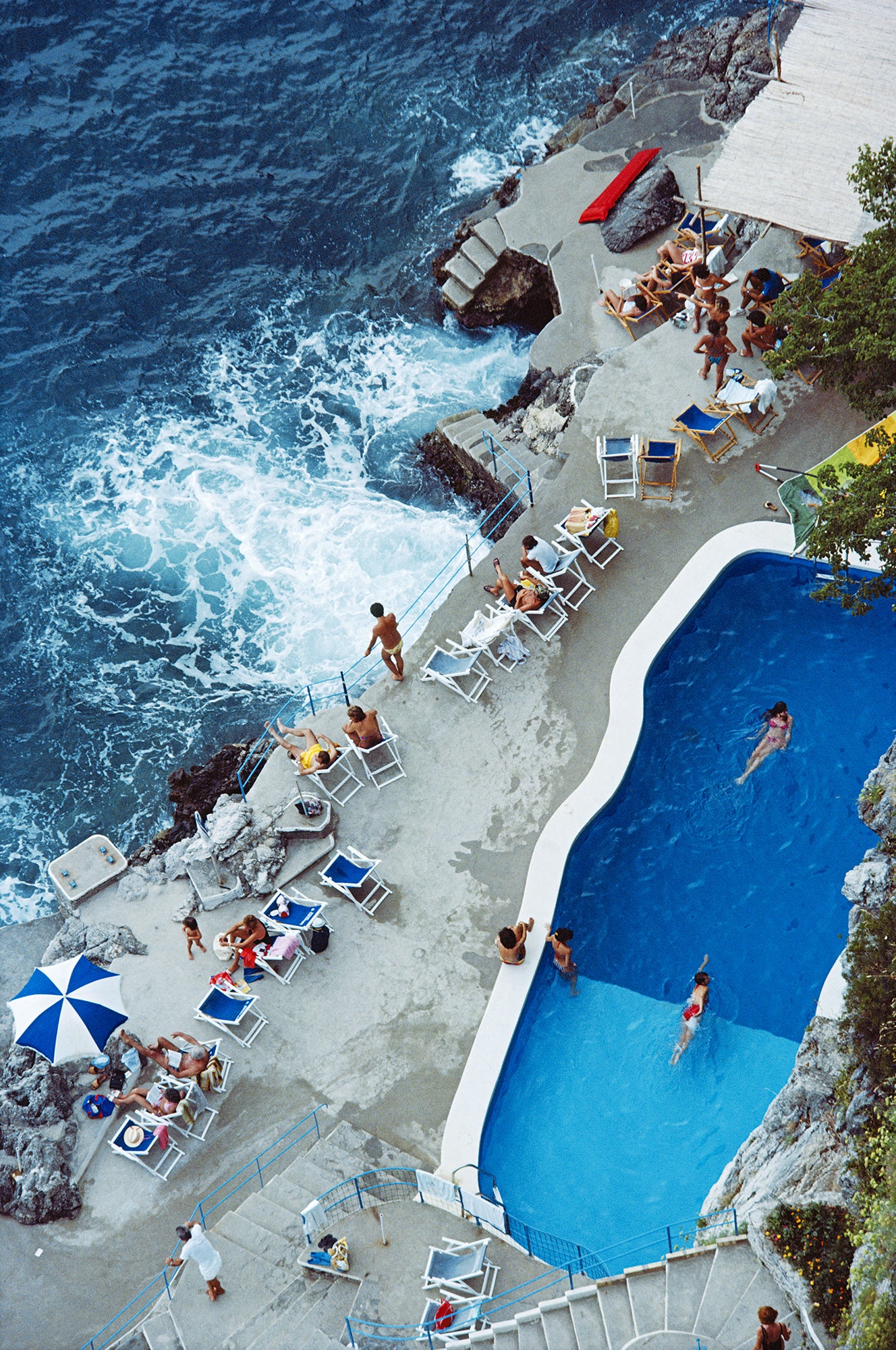 Pool on Amalfi Coast by Slim Aarons/Getty Images, 1984. Open Edition C-Type Photographic Print. Portrait orientation. Available at Electric Gallery, London, UK.