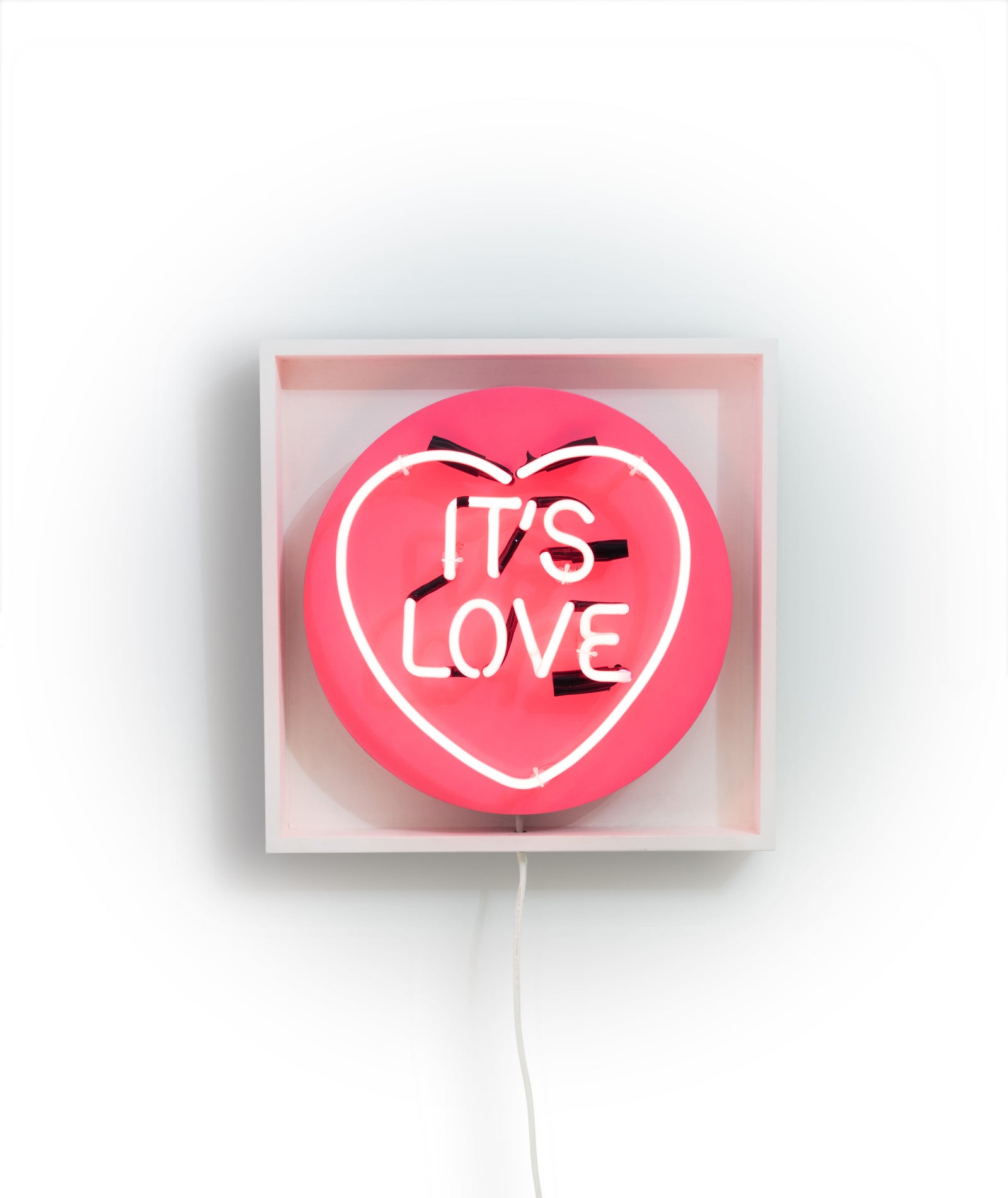 It's Love by Chris Bracey, a original love heart series with chris moon. cocktail pink neon set on wooden panel. box framed in white gallery wood. from 2012