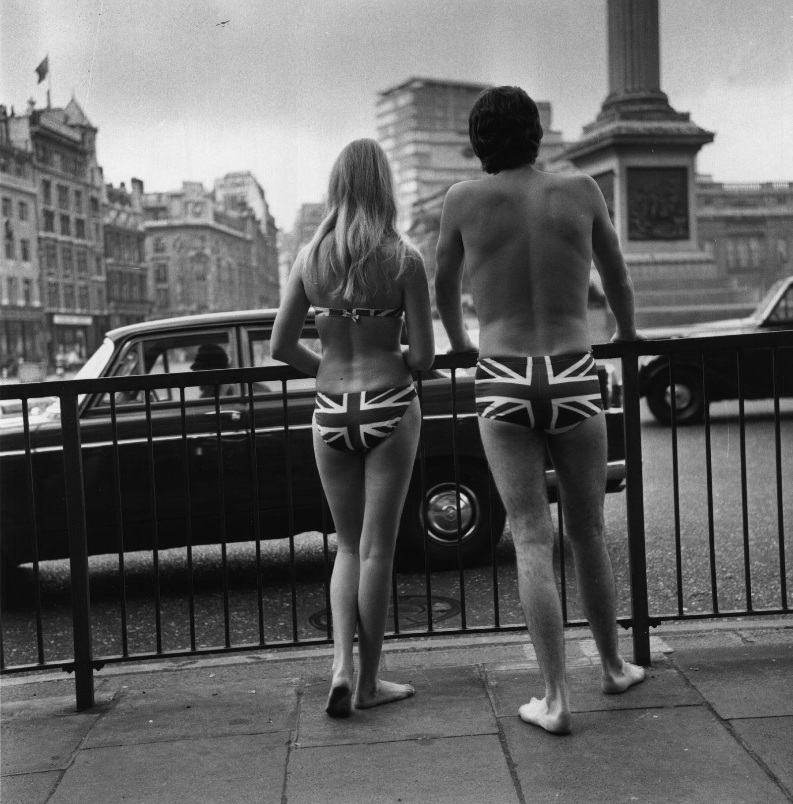 Union Jack Trunks by Michael Webb/Getty Images, 1969. Two models in Union Jack swimwear posing in Trafalgar Square to promote tourism to Gibraltar, 23rd. Open Edition Resin Photographic Print. Square orientation. Available at Electric Gallery, London, UK.